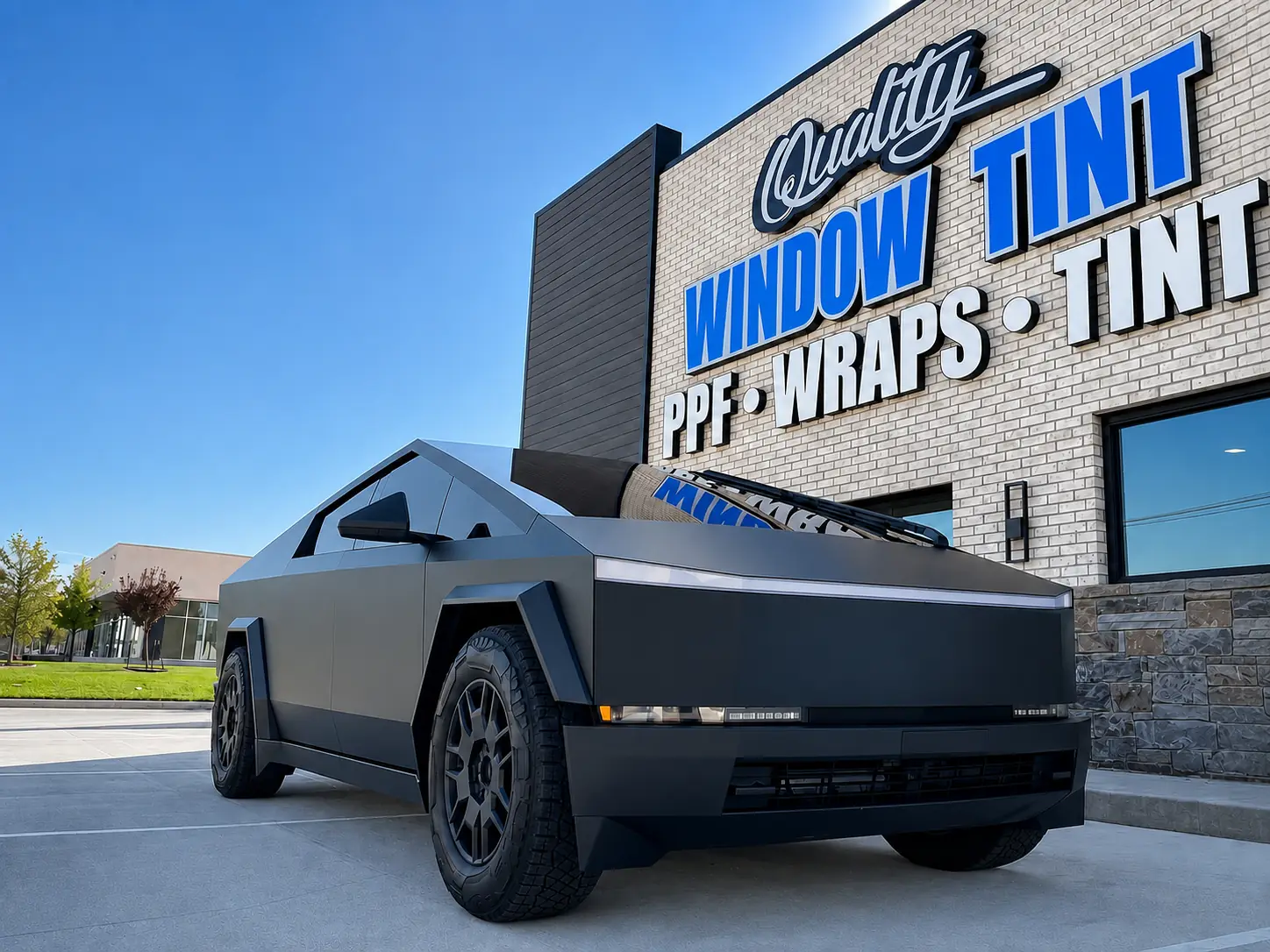 Matte-black Tesla Cybertruck outside the Quality Window Tint shop in Edmond, OK